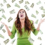 ecstatic woman trying to catch falling money